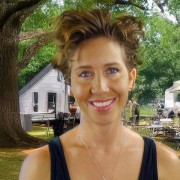 Lisa Holman Smiling woman with short dark hair, wearing a black tank top